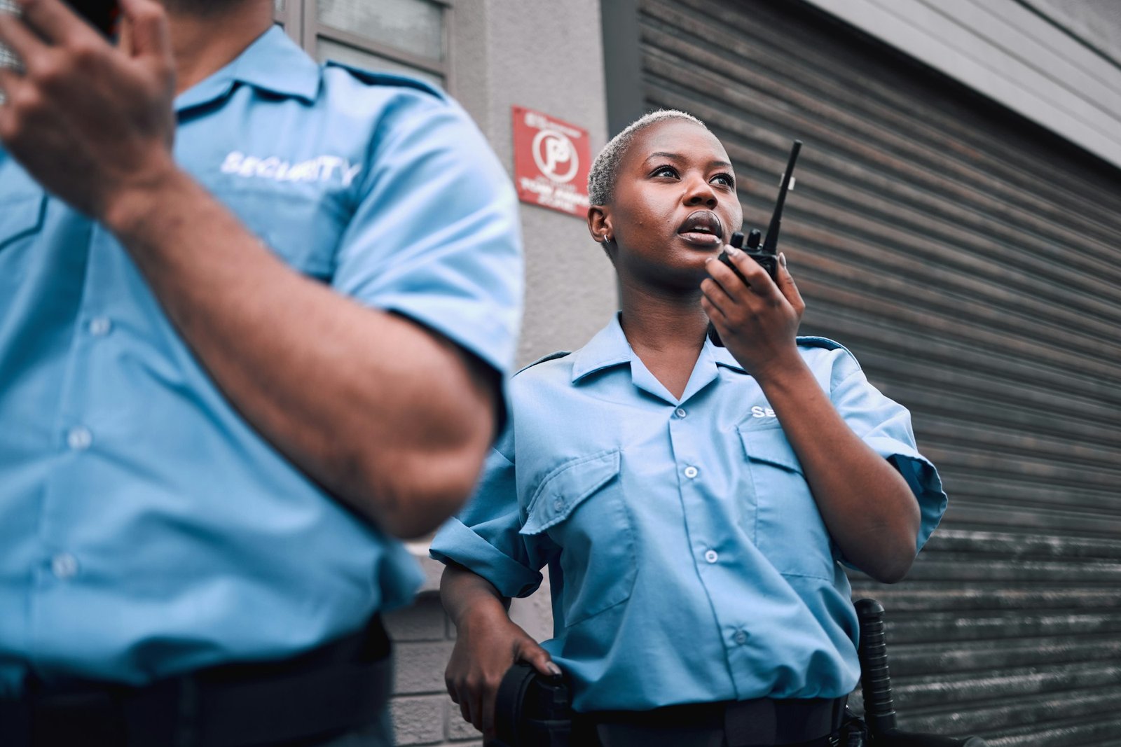 Security, walkie talkie and a black woman police officer in the city during her patrol for safety o